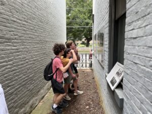 Students in Freedom Courtyard's brick hallway, looking at signs