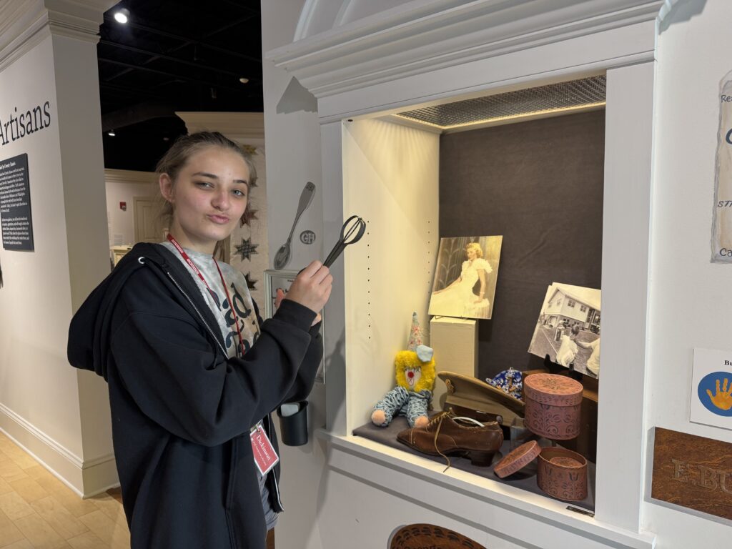 Girl holding kitchen utensil