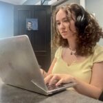 Girl writing at a computer
