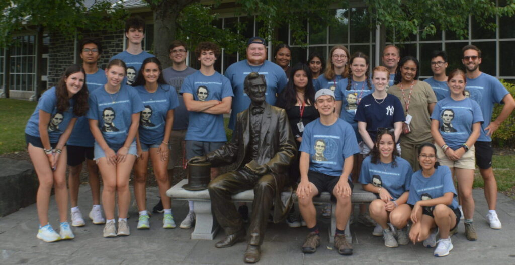 Students standing around Abraham Lincoln statue.