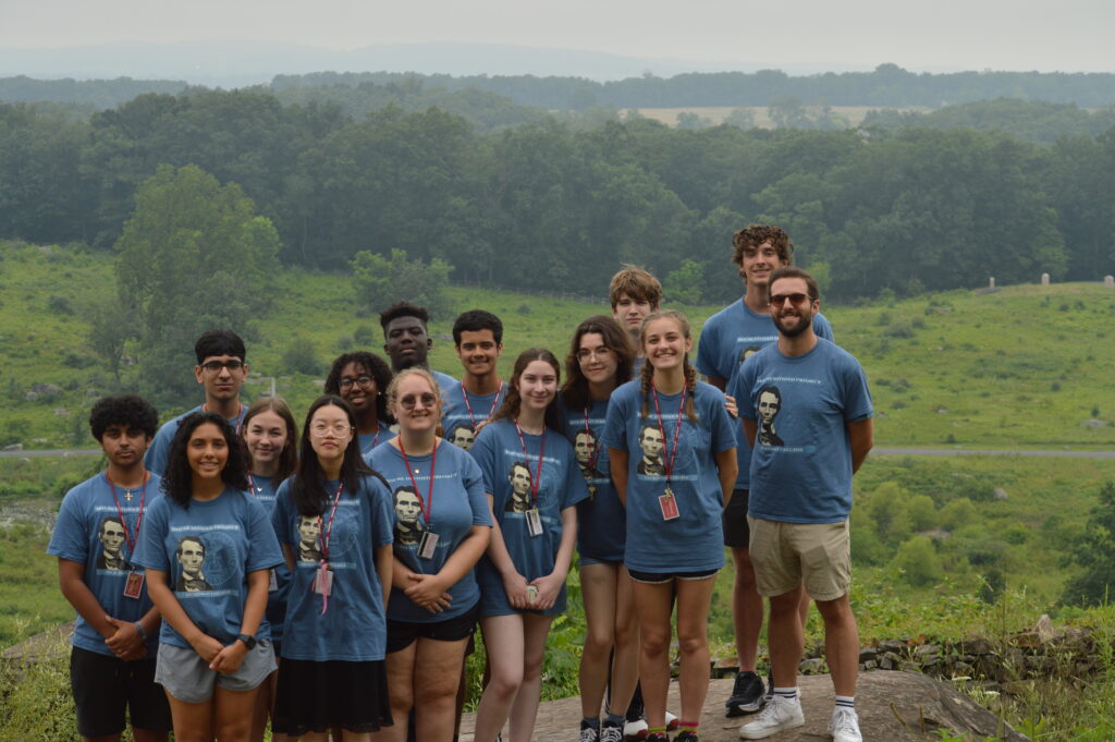 Students standing with field in the background