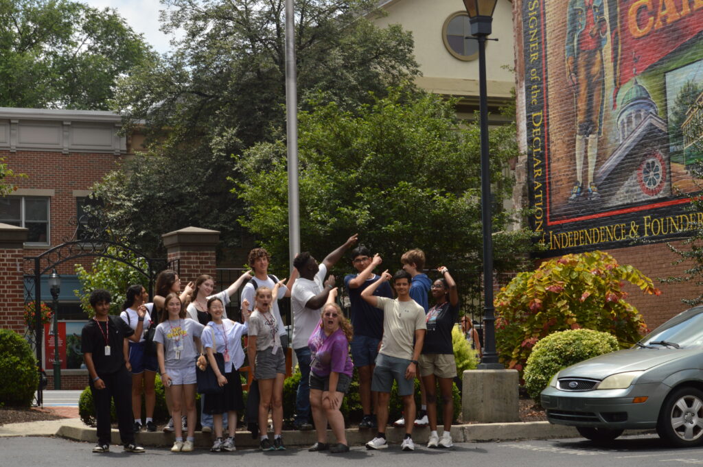 Students pointing to mural