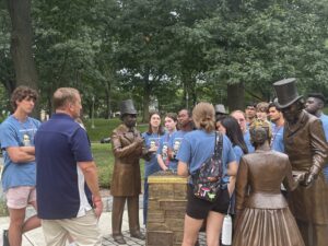 Students standing around statues.