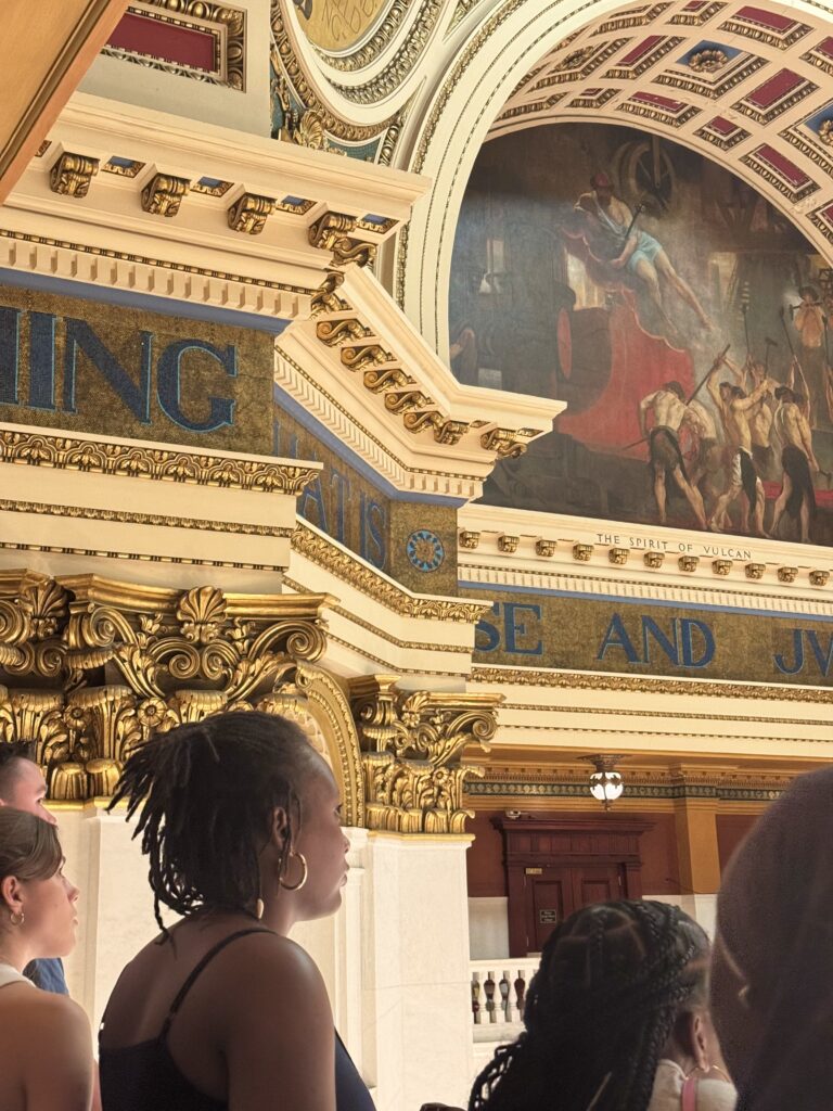 A student looking up at the artwork of the capital rotunda dome