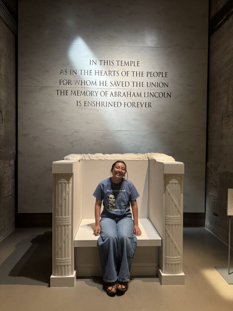 A girl sitting in a large marble chair