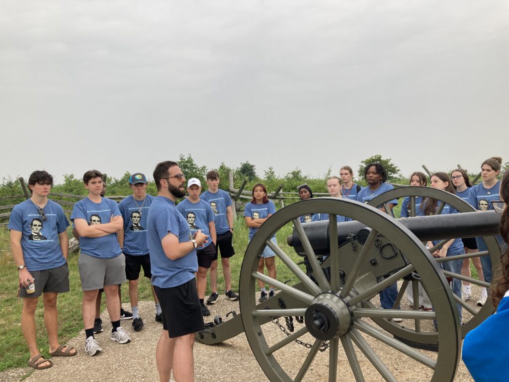 A group of people standing around a cannon