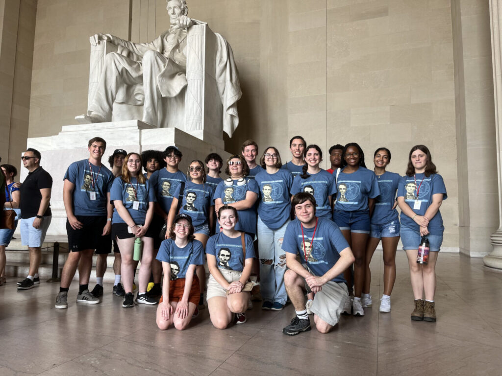 students in front of Lincoln statue