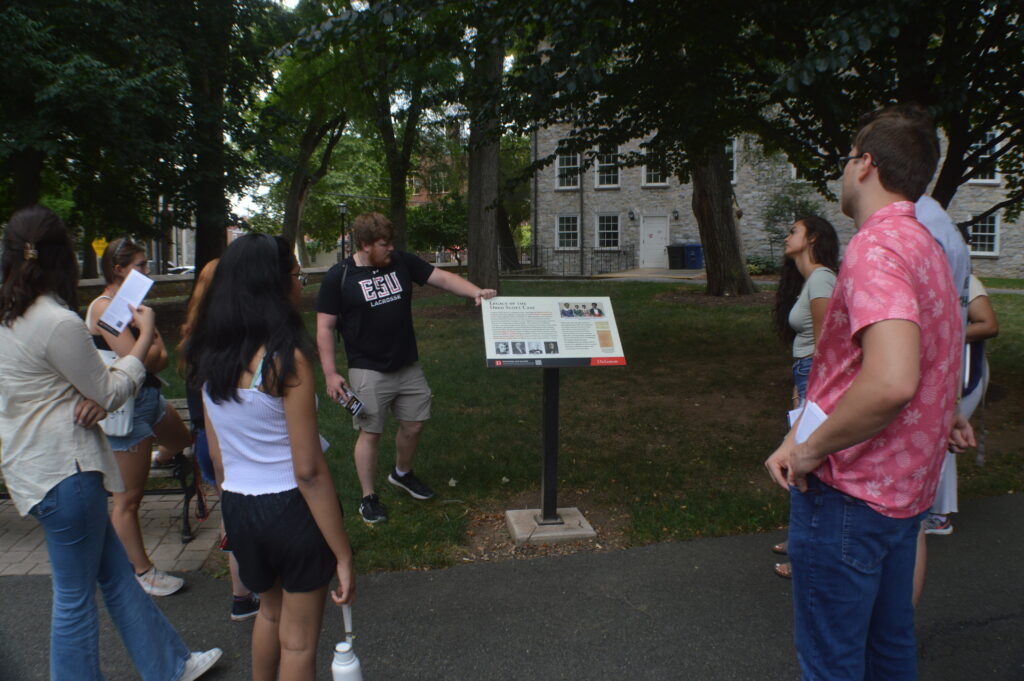 students around a plaque