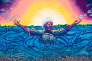 mural woman outstretched arms water